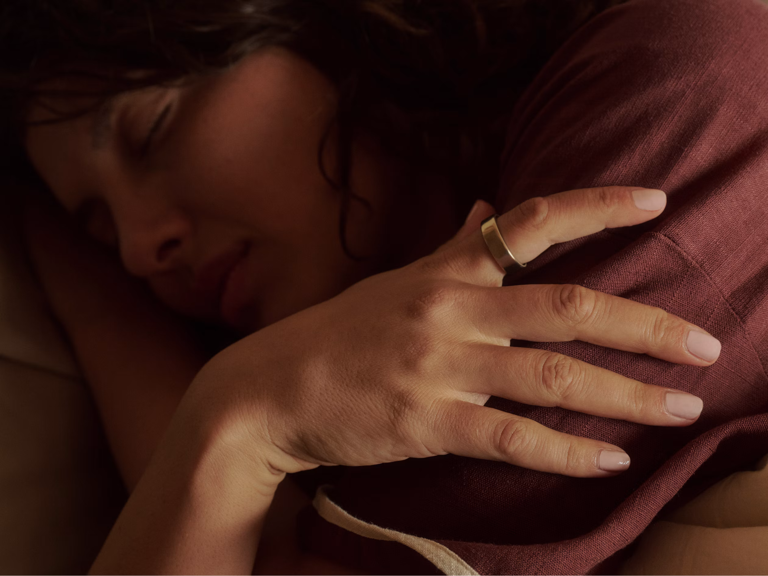 Person winding down for bedtime in a dimly lit bedroom