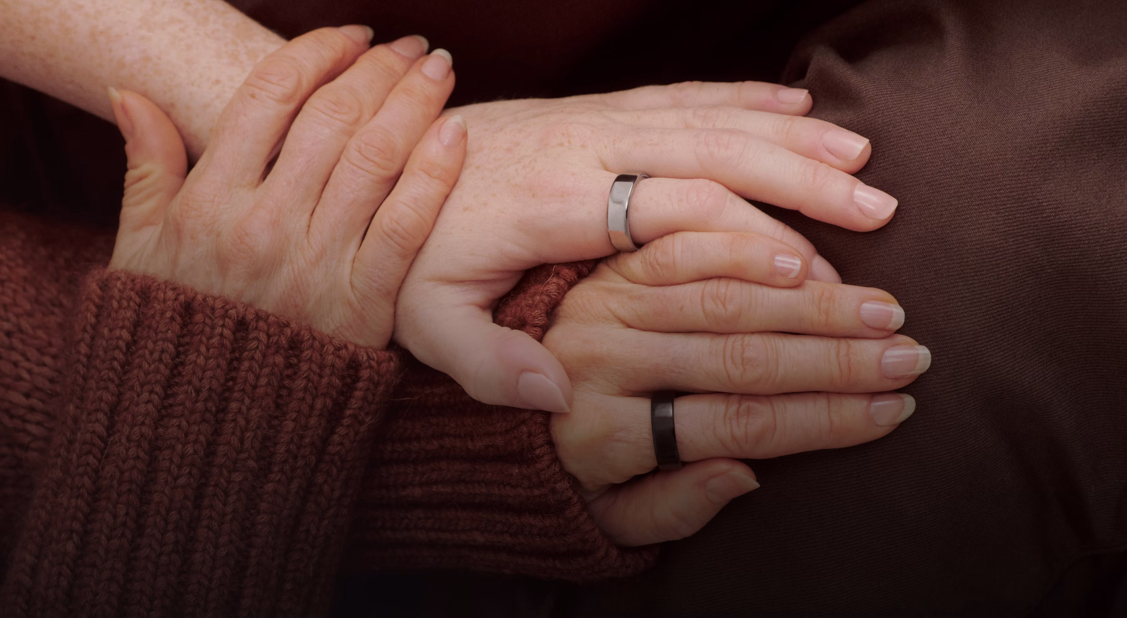 Holding hands each wearing an Oura Ring 5