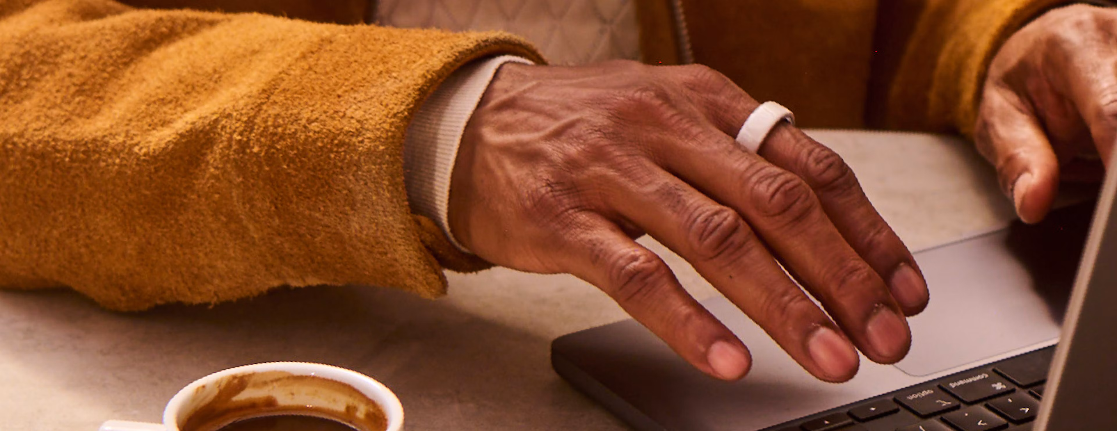 Man typing wearing an Oura Ring